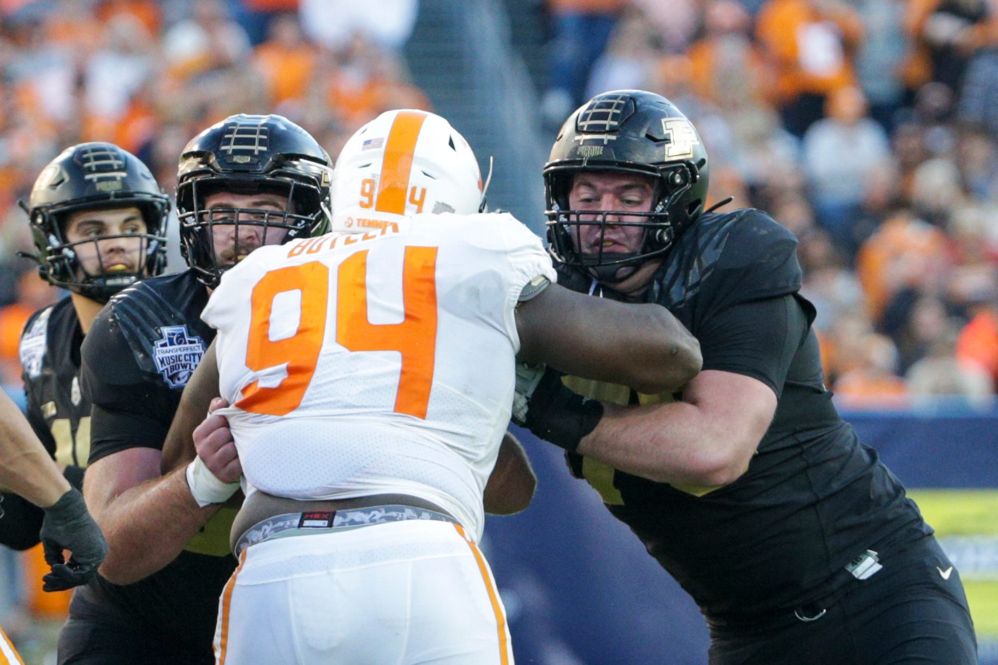 Purdue offensive lineman Gus Hartwig (53) and Purdue offensive lineman Spencer Holstege (75) block Tennessee defensive lineman Matthew Butler (94) during the second quarter of the Music City Bowl, Thursday, Dec. 30, 2021, at Nissan Stadium in Nashville.