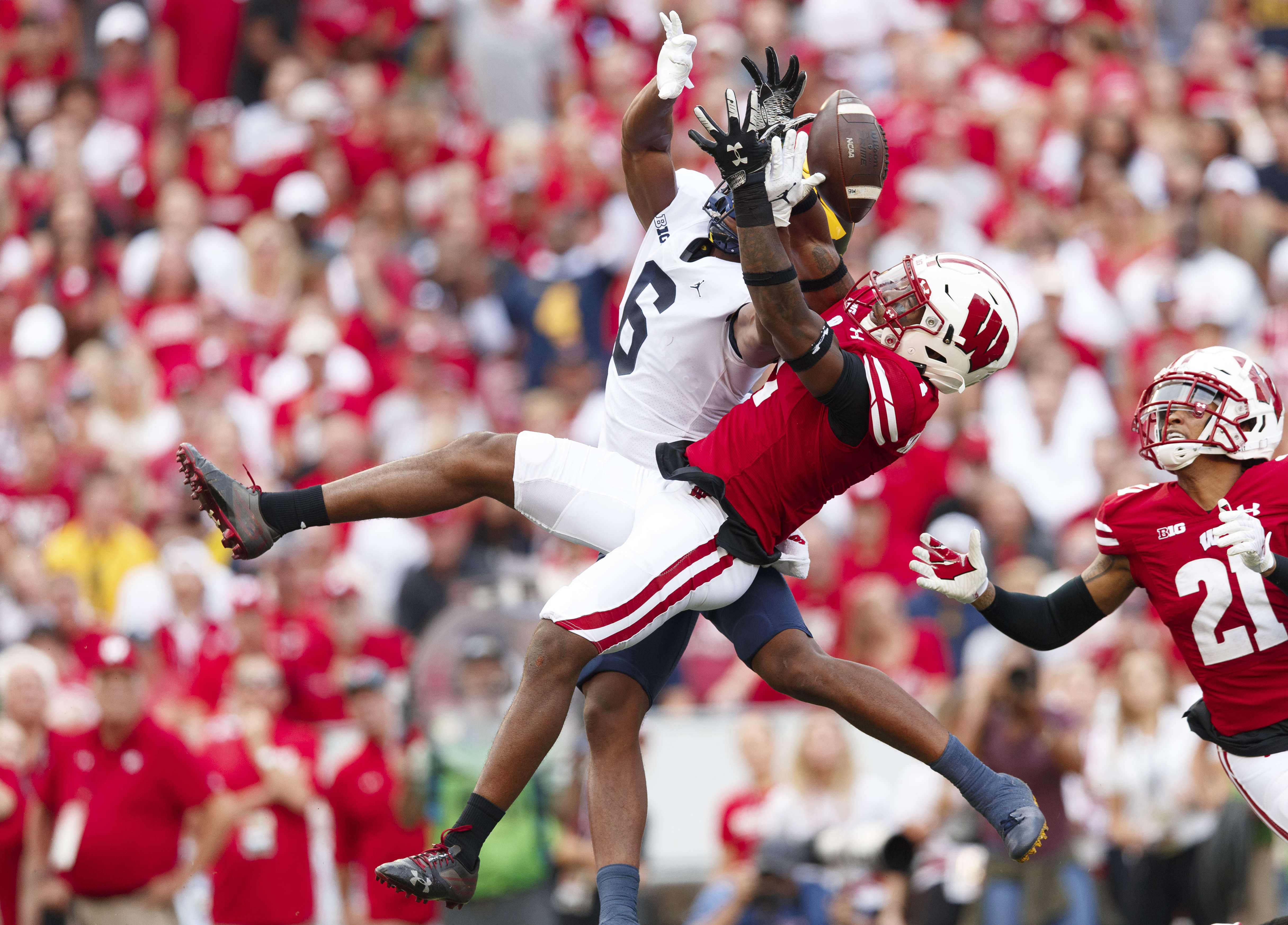 Wisconsin Badgers cornerback Faion Hicks (1) defends the pass intended for Michigan Wolverines wide receiver Cornelius Johnson (6) during the second quarter at Camp Randall Stadium.