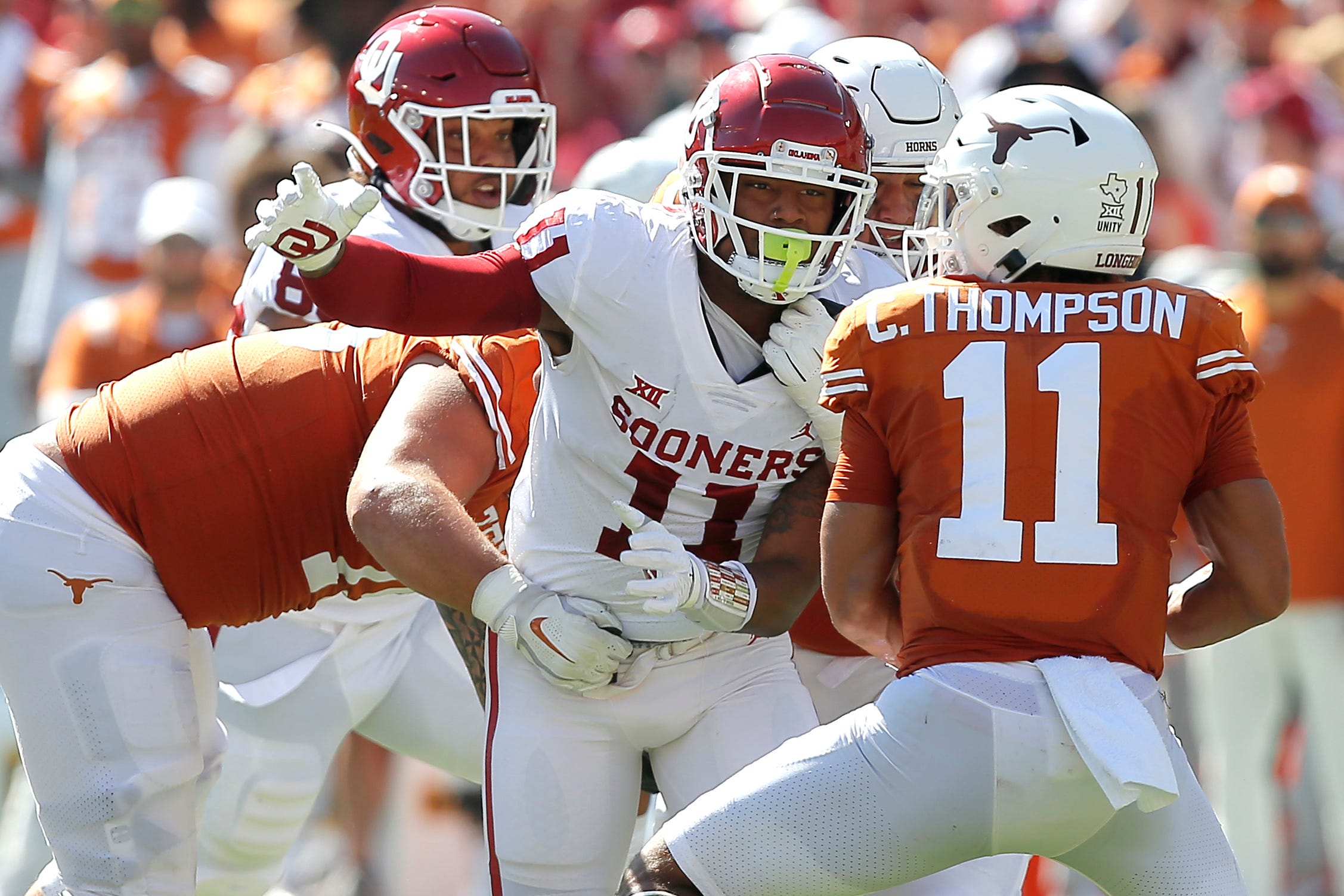 Oklahoma's Nik Bonitto (11) tries to get to Texas' Casey Thompson (11) during the Red River Showdown college football game between the University of Oklahoma Sooners (OU) and the University of Texas (UT) Longhorns at the Cotton Bowl in Dallas, Saturday, Oct. 9, 2021. Oklahoma won 55-48.