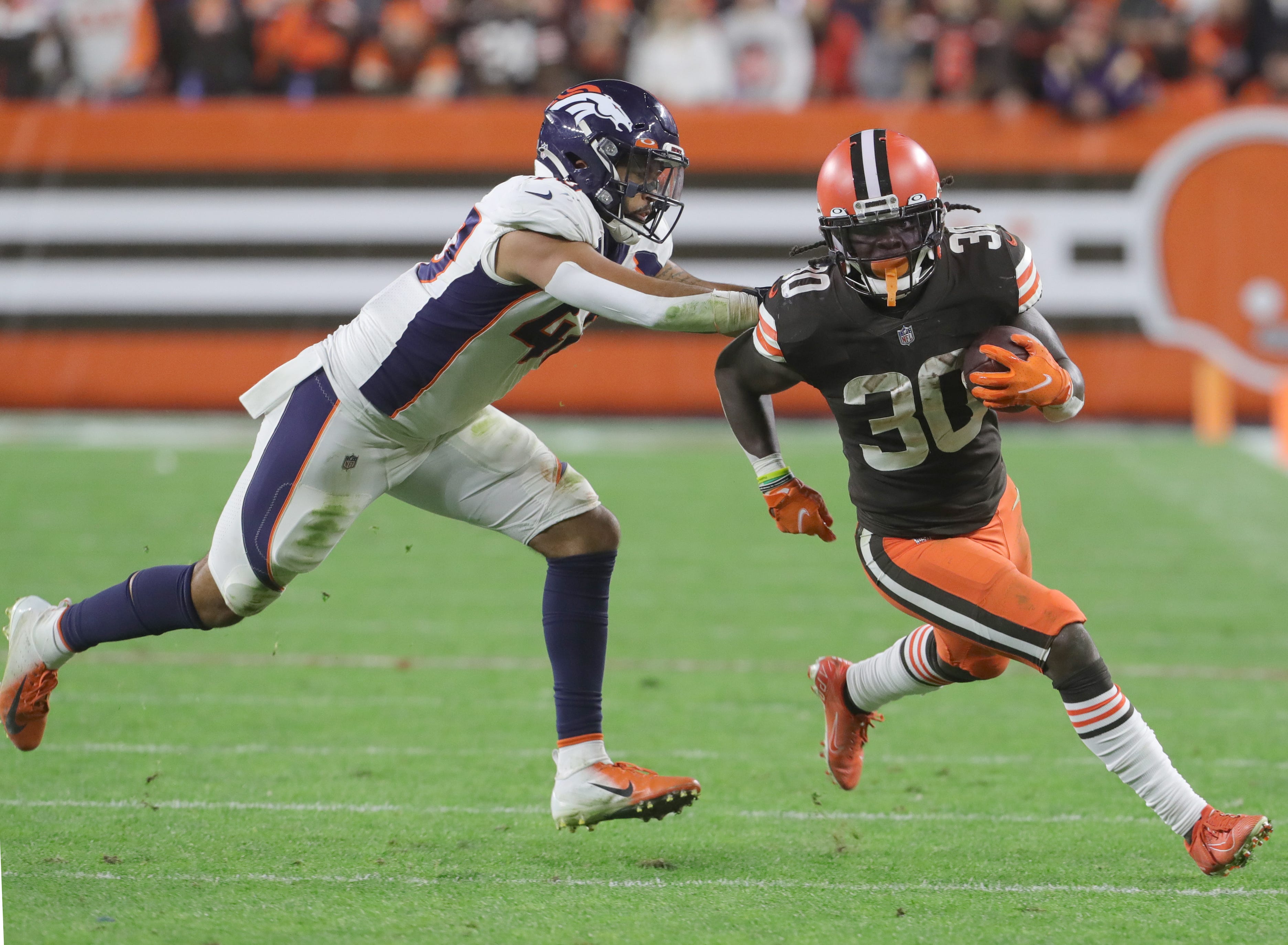 Cleveland Browns running back D'Ernest Johnson gets away from Denver's Justin Strnad on Thursday, Oct. 21, 2021 in Cleveland, Ohio, at FirstEnergy Stadium. The Browns won the game 17-14.