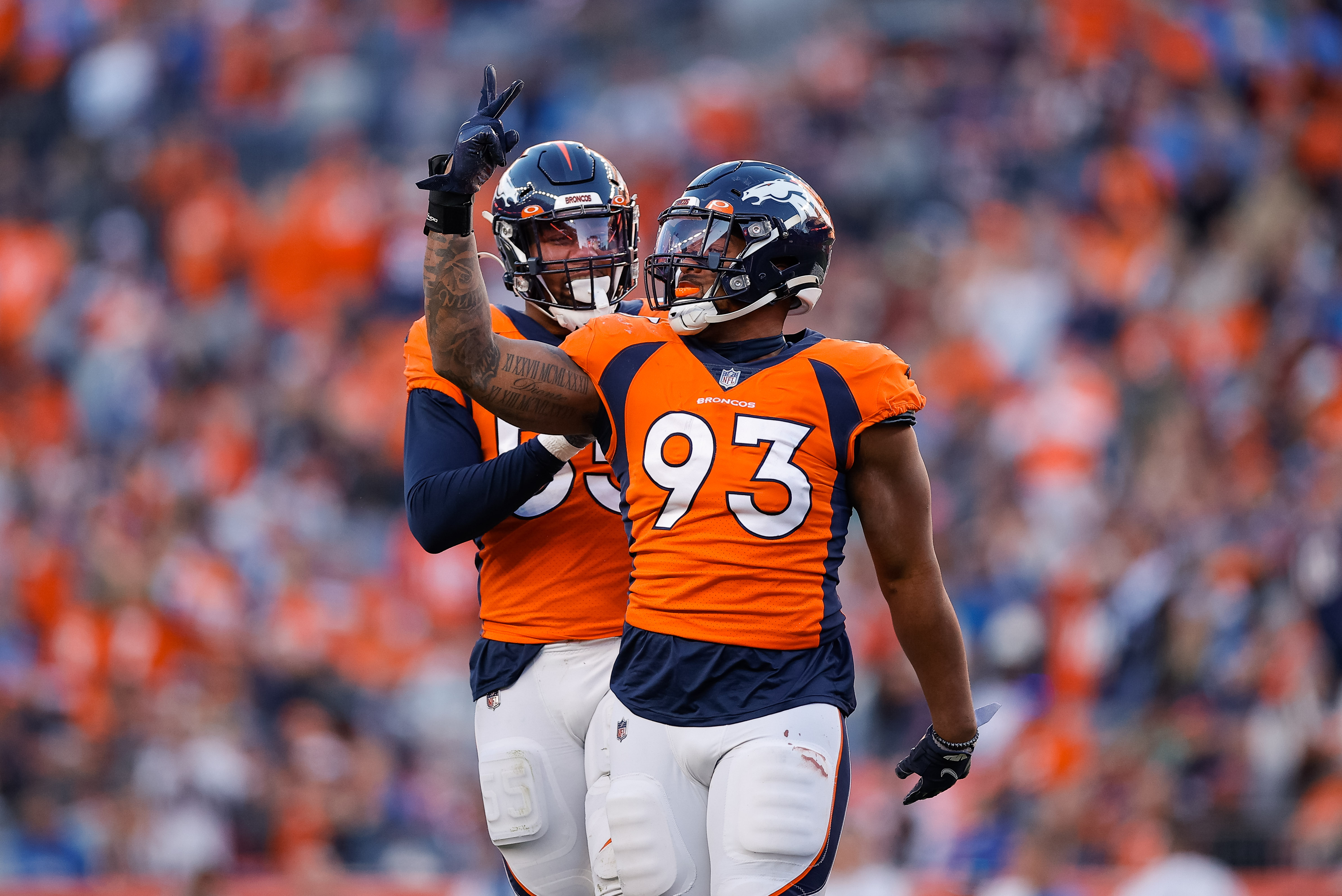 Denver Broncos defensive end Dre'Mont Jones (93) celebrates with linebacker Bradley Chubb (55) after a play in the third quarter against the Detroit Lions at Empower Field at Mile High. 