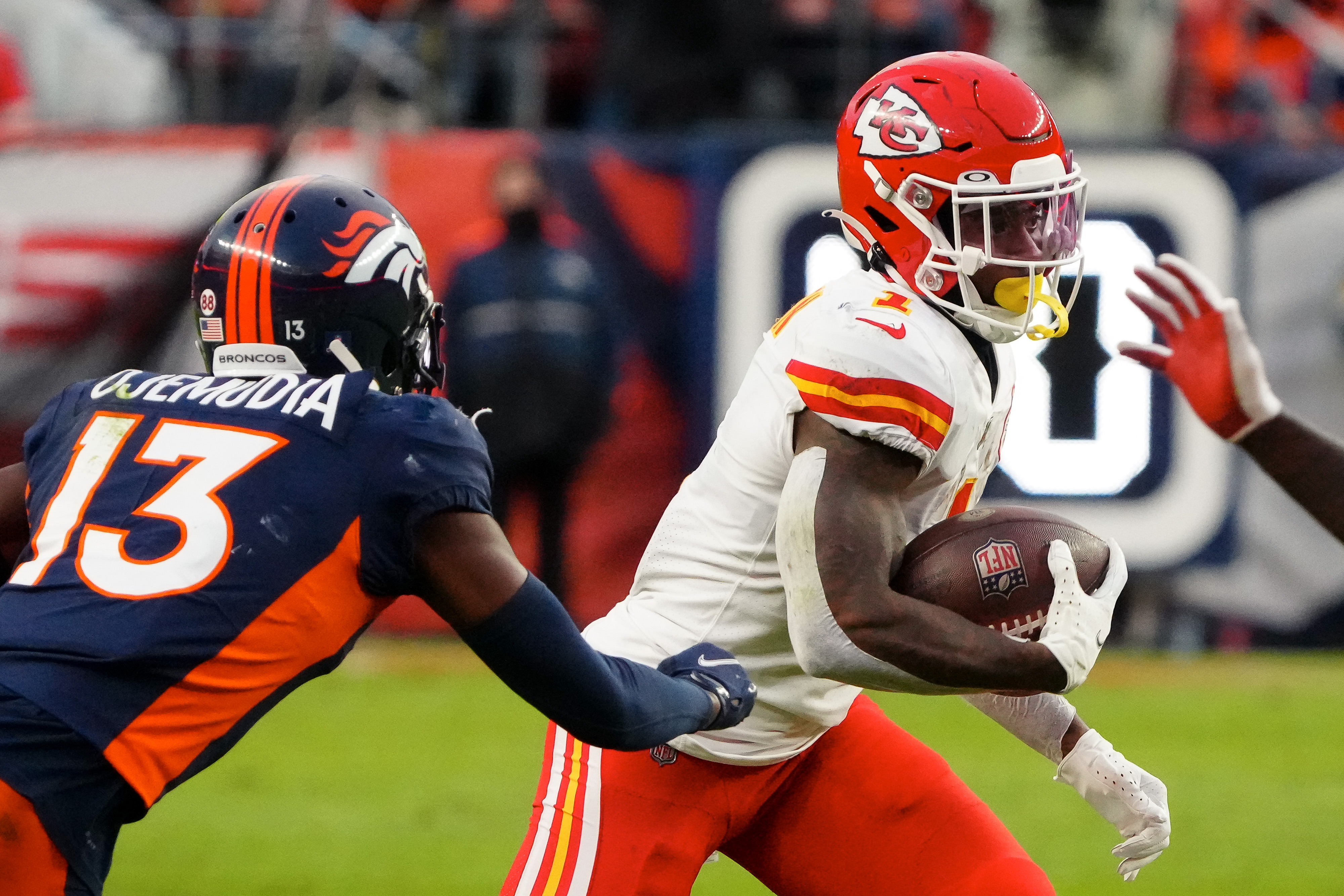 Kansas City Chiefs running back Jerick McKinnon (1) runs the ball against Denver Broncos cornerback Michael Ojemudia (13) in the third quarter at Empower Field at Mile High.