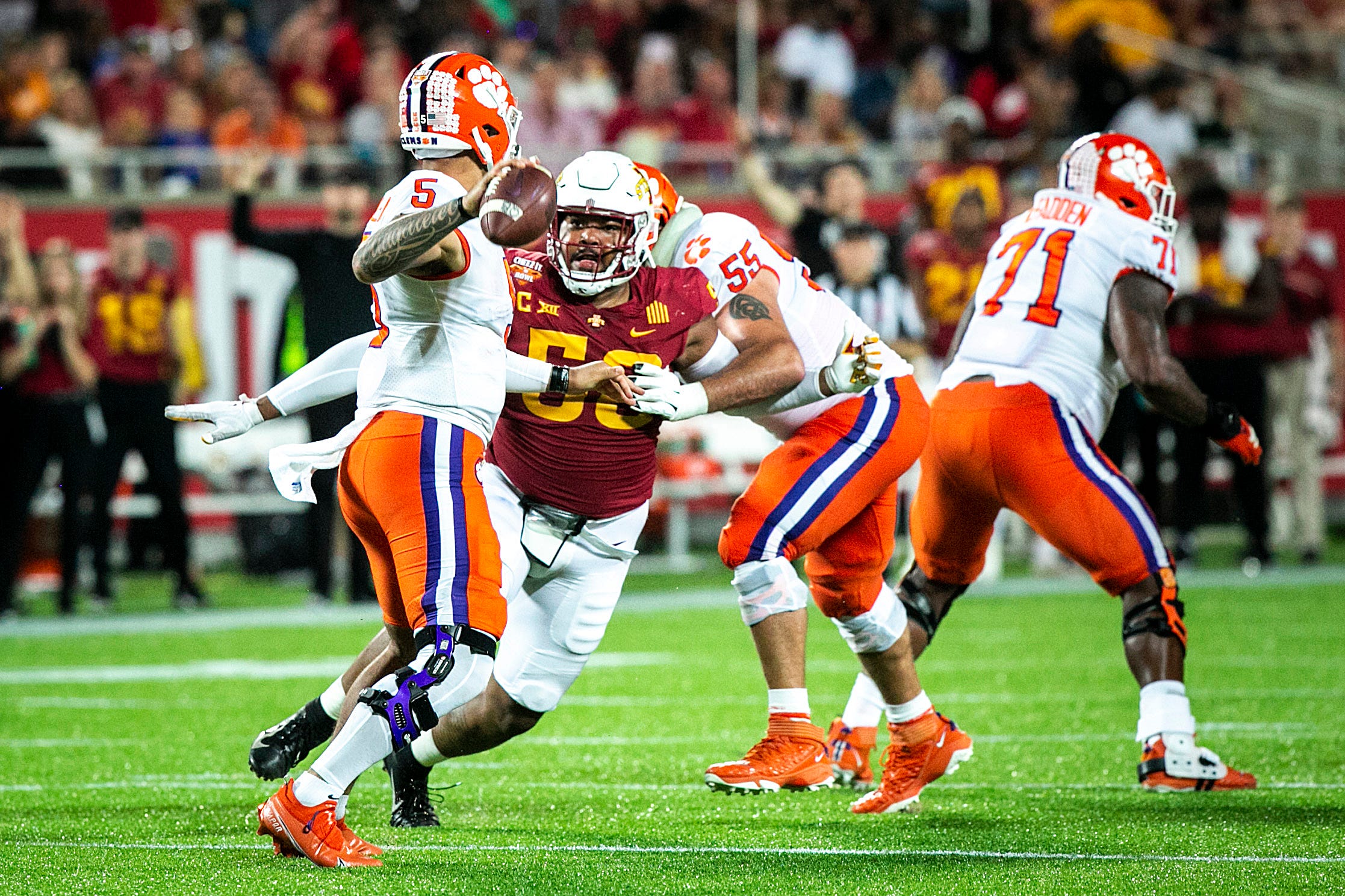 Iowa State defensive end Eyioma Uwazurike (58) pressures Clemson quarterback DJ Uiagalelei (5) during a NCAA college football game in the Cheez-It Bowl, Wednesday, Dec. 29, 2021, at Camping World Stadium in Orlando, Fla.