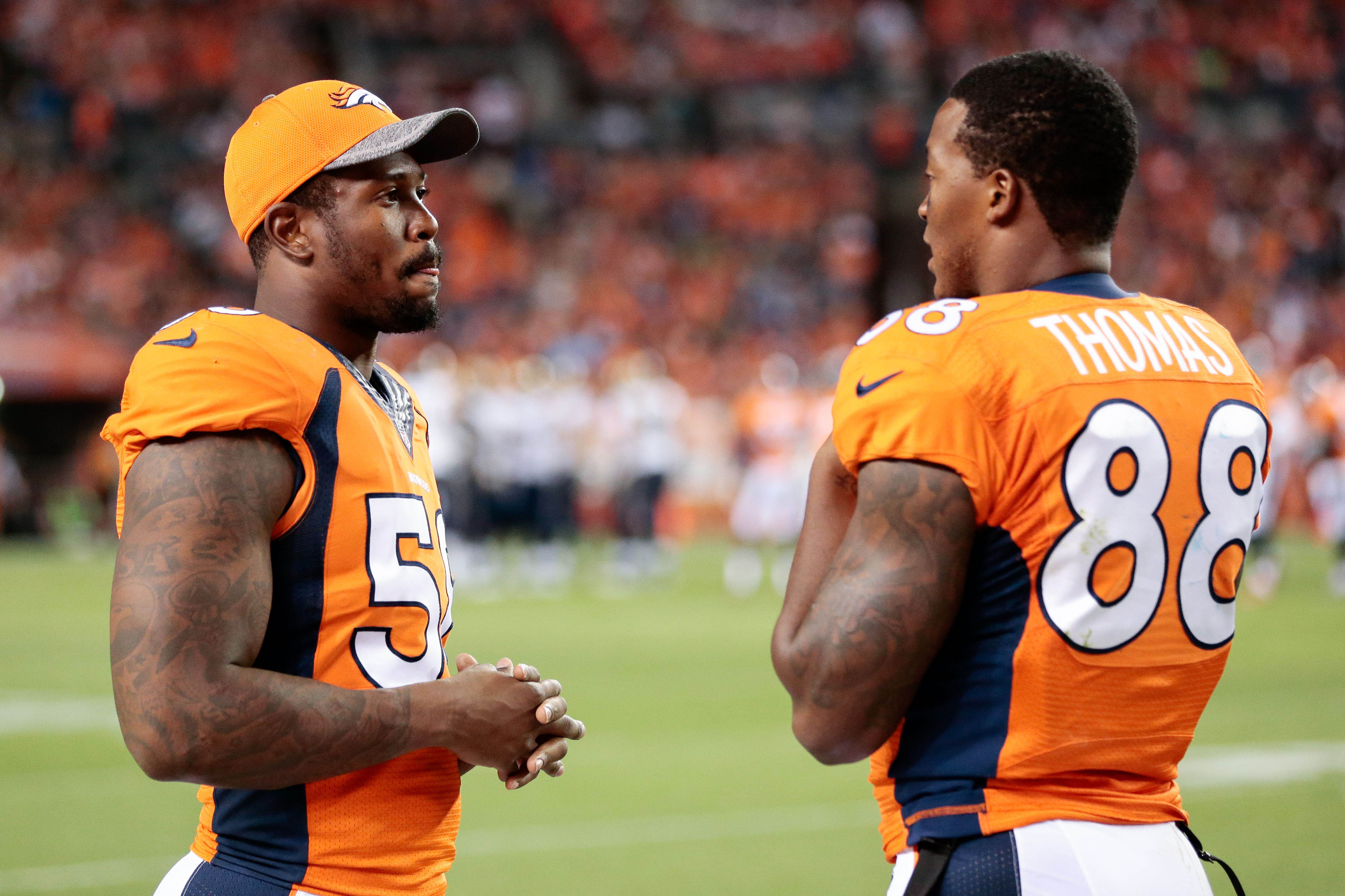 Denver Broncos outside linebacker Von Miller (58) talks with wide receiver Demaryius Thomas (88) in the third quarter against the Los Angeles Rams at Sports Authority Field at Mile High. The Broncos defeated the Rams 17-9.