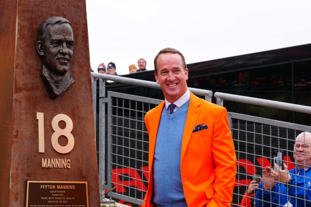 Peyton Manning with his bust at Empower Field at Mile High Stadium's Ring of Fame Plaza. Credit: Ron Chenoy, USA TODAY Sports.