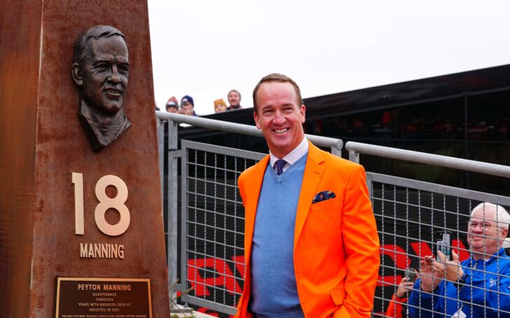 Peyton Manning with his bust at Empower Field at Mile High Stadium's Ring of Fame Plaza. Credit: Ron Chenoy, USA TODAY Sports.