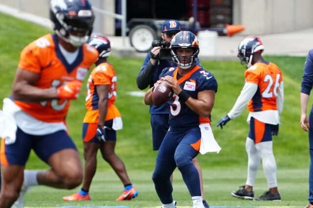 Denver Broncos quarterback Russell Wilson (3) drops back to pass the ball during OTA workouts at the UC Health Training Center.