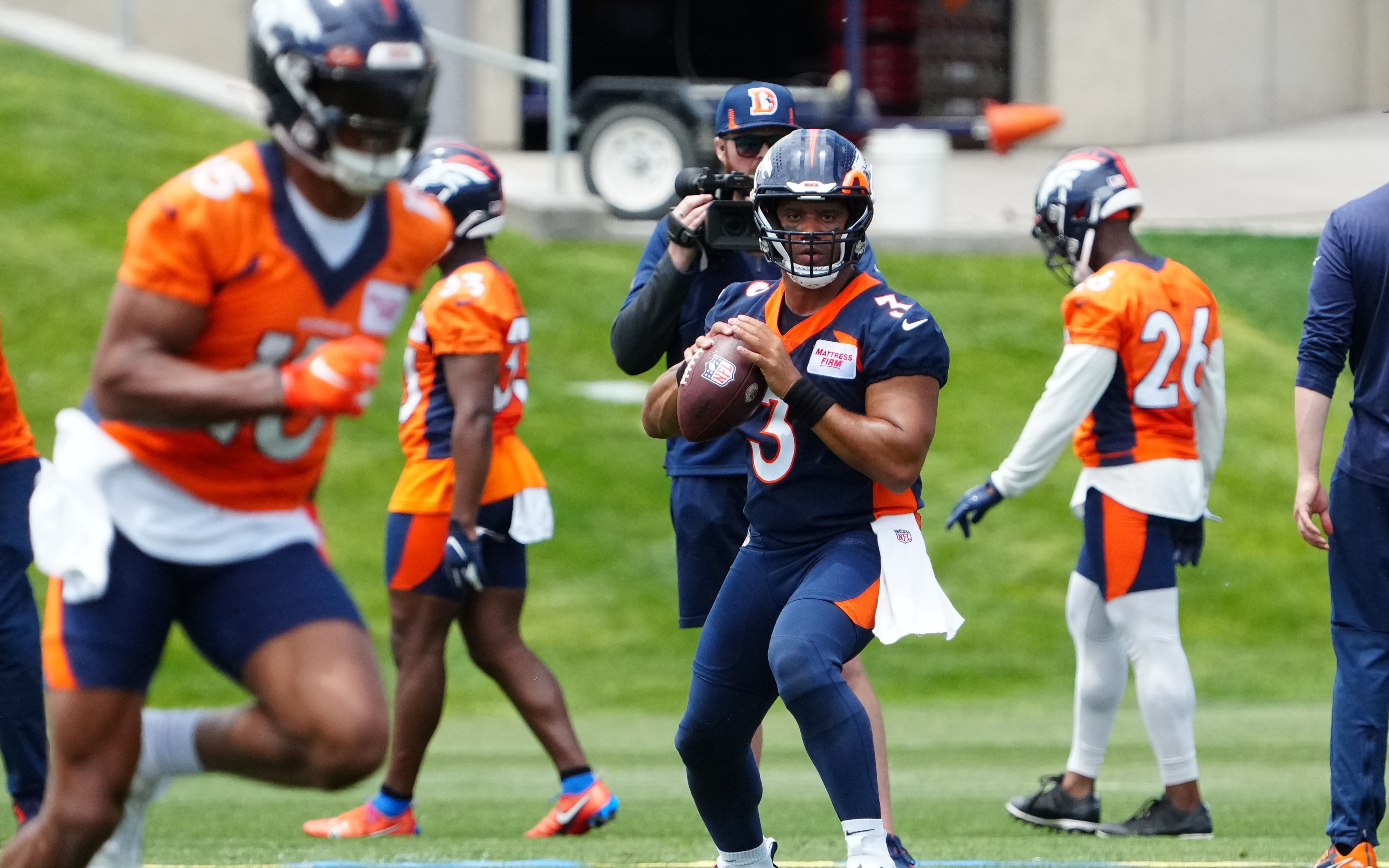 Denver Broncos quarterback Russell Wilson (3) drops back to pass the ball during OTA workouts at the UC Health Training Center.