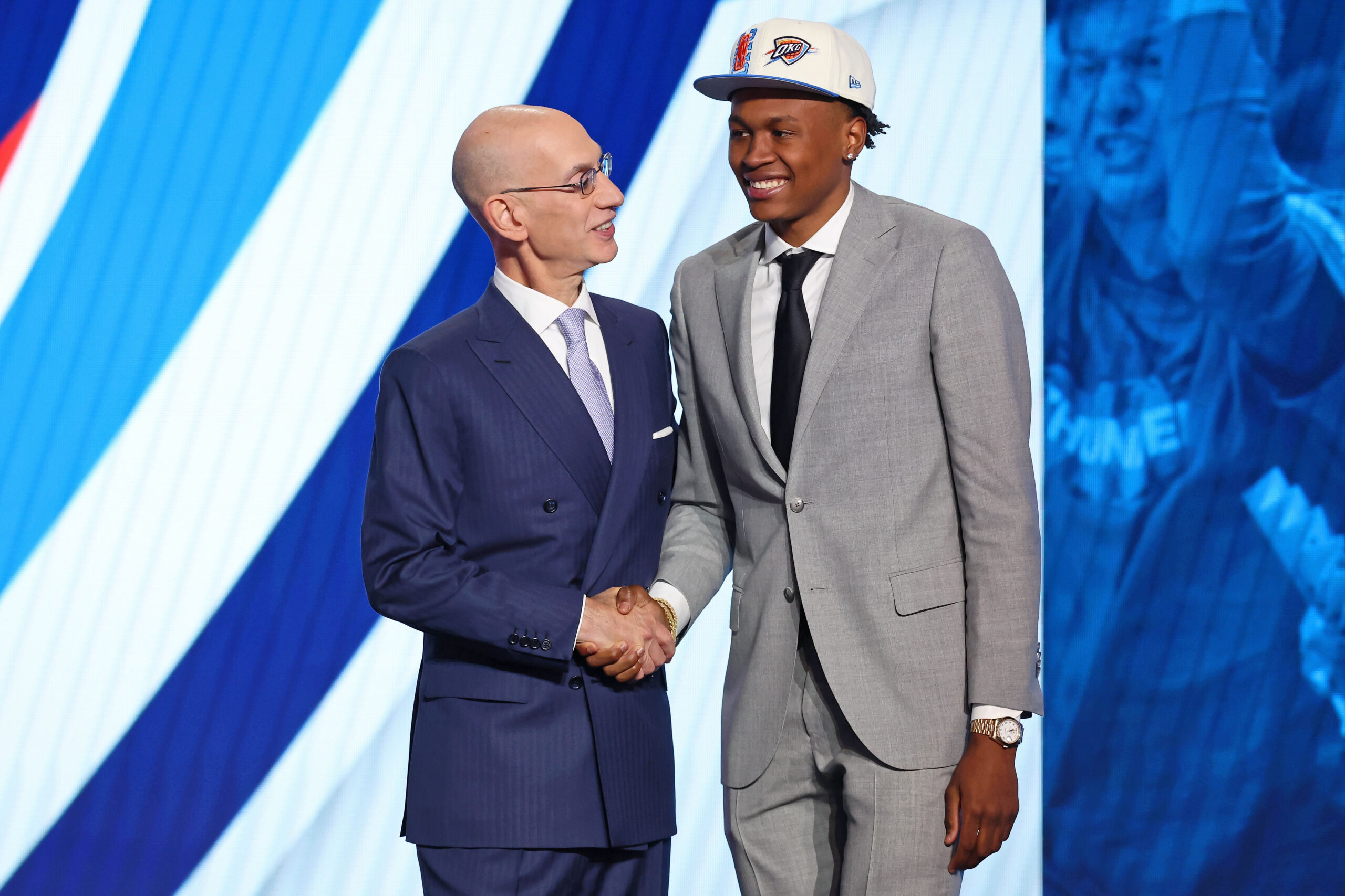 One of the Denver Nuggets' selections from the NBA Draft, Peyton Watson,  second from left, holds up his jersey for a family photo with, from left to  right, his father Julio, mother