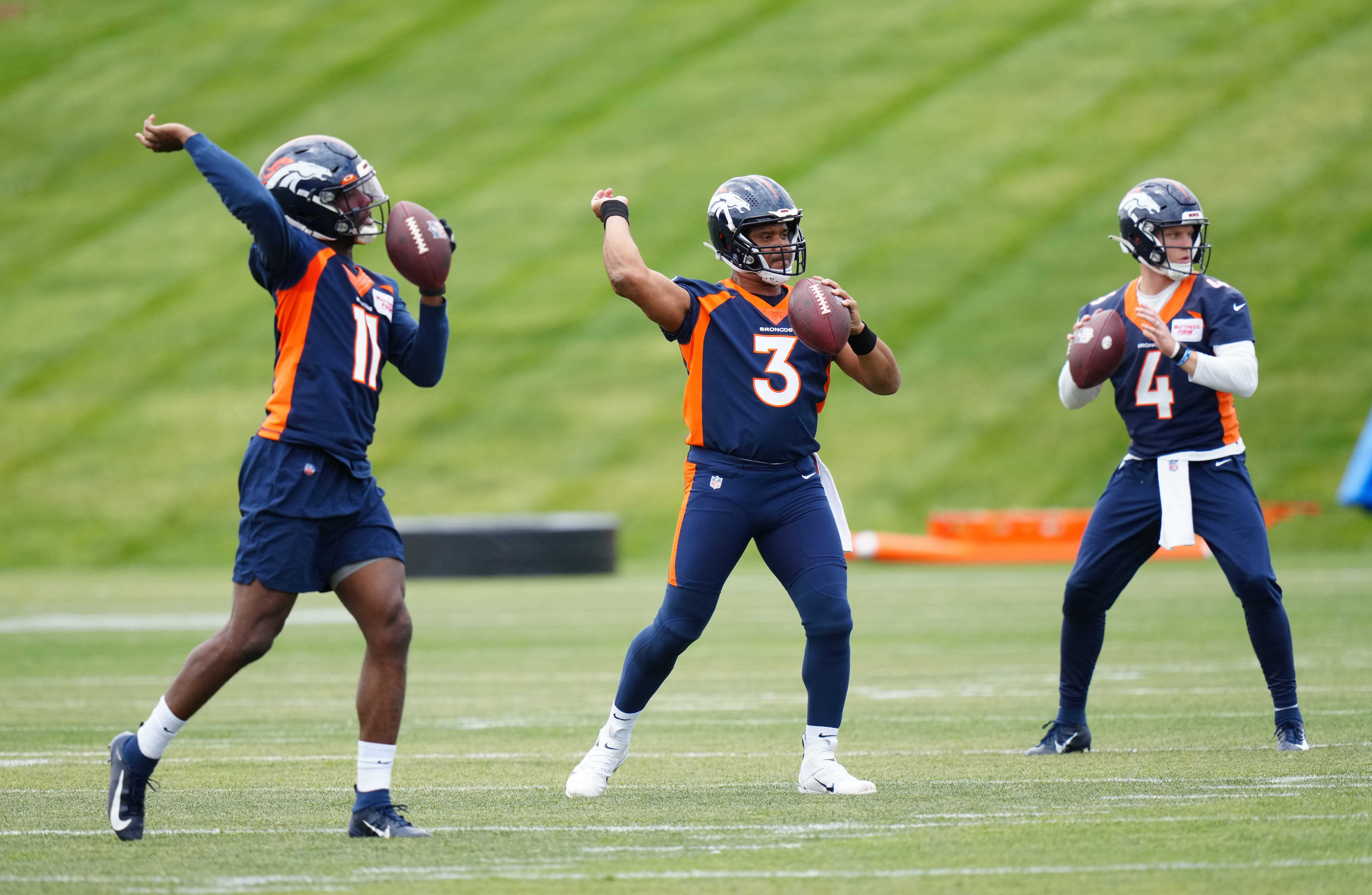 Denver Broncos quarterback Josh Johnson (11) and quarterback Russel Wilson (3) and quarterback Brett Rypien (4) during OTA workouts at the UC Health Training Center.