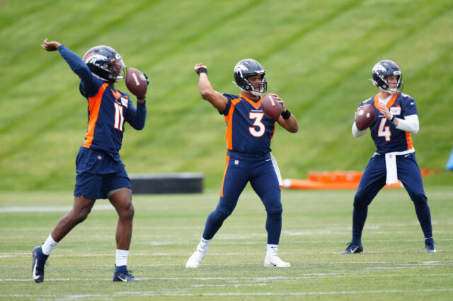 Denver Broncos quarterback Josh Johnson (11) and quarterback Russel Wilson (3) and quarterback Brett Rypien (4) during OTA workouts at the UC Health Training Center.