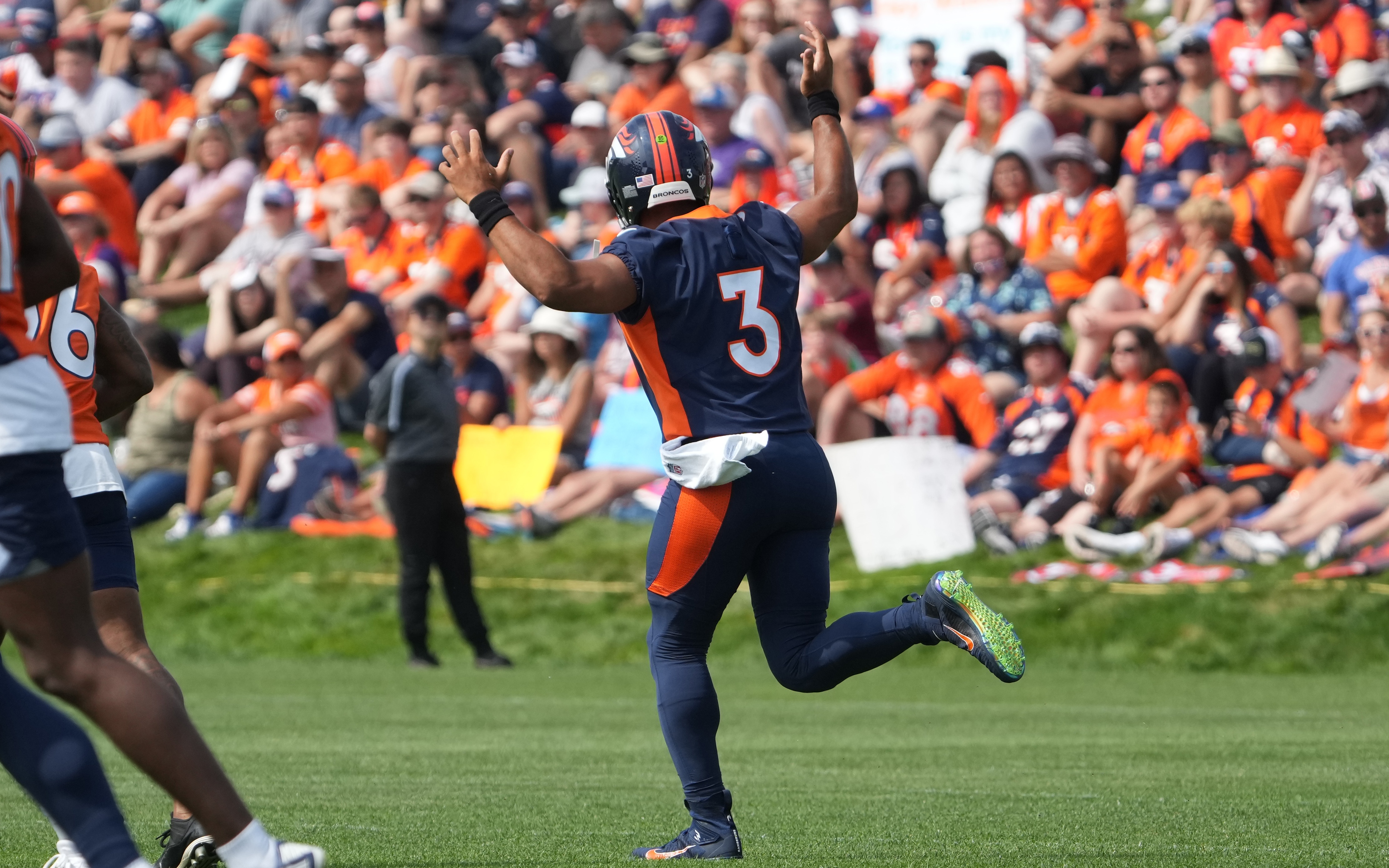 Russell Wilson lighting it up at Broncos training camp. Credit: Ron Chenoy, USA TODAY Sports.