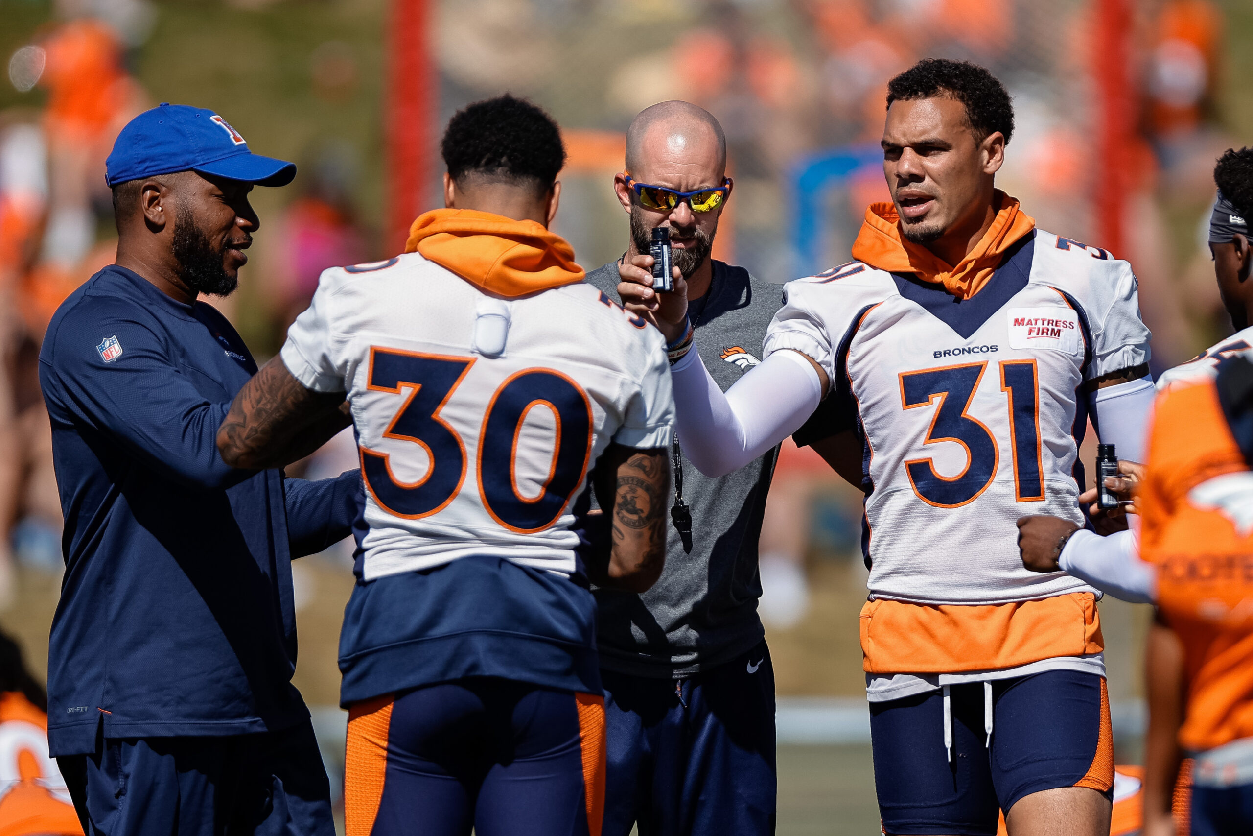 Justin Simmons and PJ Locke of the Denver Broncos run through