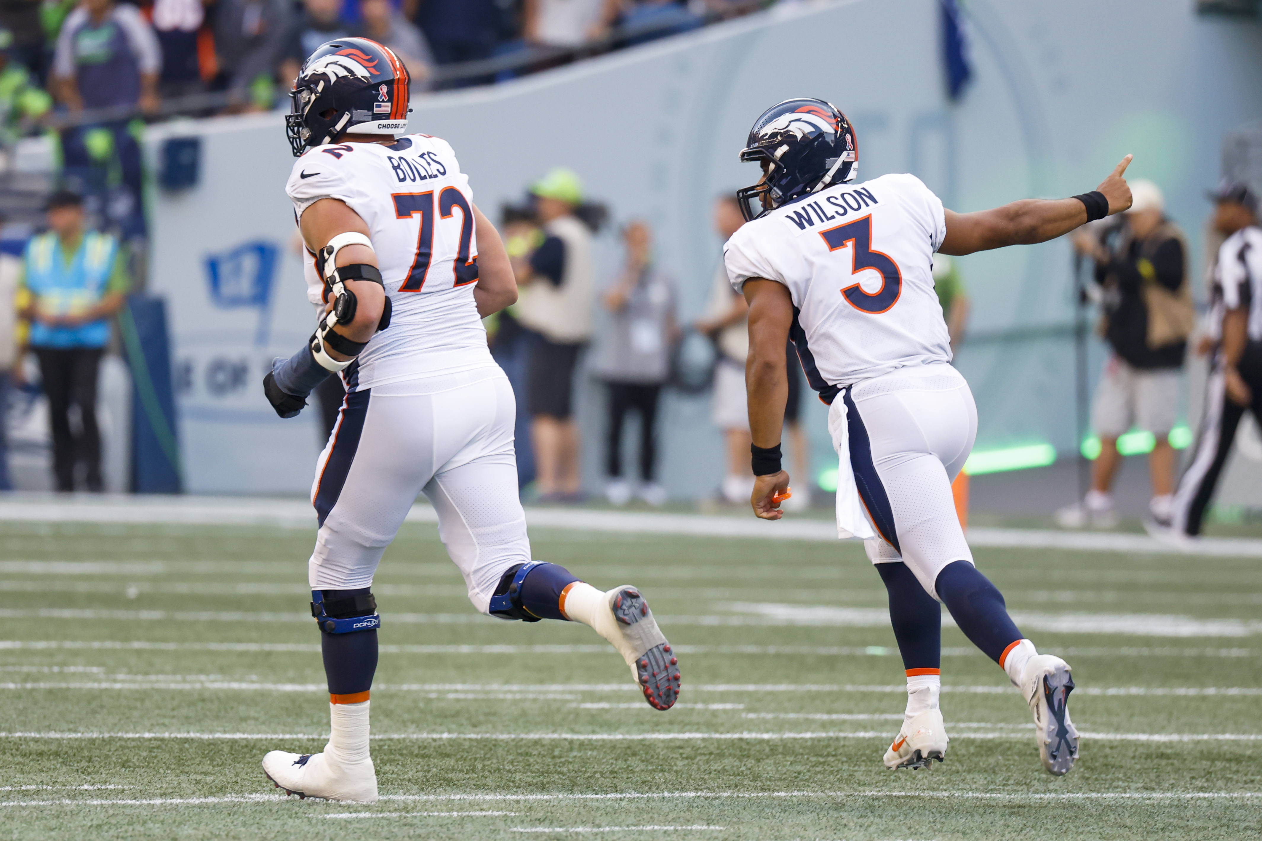 Denver Broncos quarterback Russell Wilson (3) celebrates after throwing a touchdown pass against the Seattle Seahawks during the second quarter at Lumen Field.