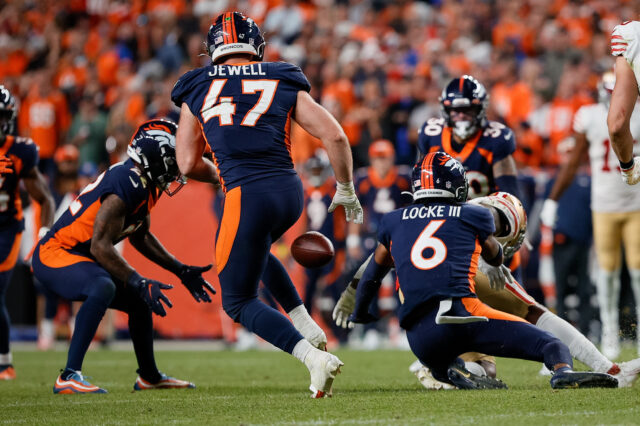 Denver Broncos safety P.J. Locke (6) knocks the ball away from San Francisco 49ers running back Jeff Wilson Jr. (22) as safety Kareem Jackson (22) recovers the fumble and linebacker Josey Jewell (47) looks on in the fourth quarter at Empower Field at Mile High.