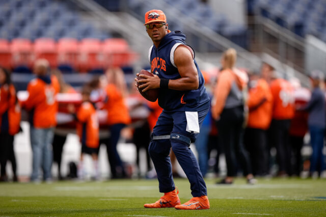 Denver Broncos quarterback Russell Wilson (3) stretches before the game against the New York Jets at Empower Field at Mile High.