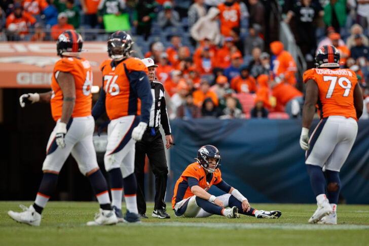 Denver Broncos quarterback Brett Rypien (4) sits on the ground after a pass attempt as center Lloyd Cushenberry III (79) and offensive tackle Calvin Anderson (76) and guard Dalton Risner (66) look on in the fourth quarter against the New York Jets at Empower Field at Mile High.