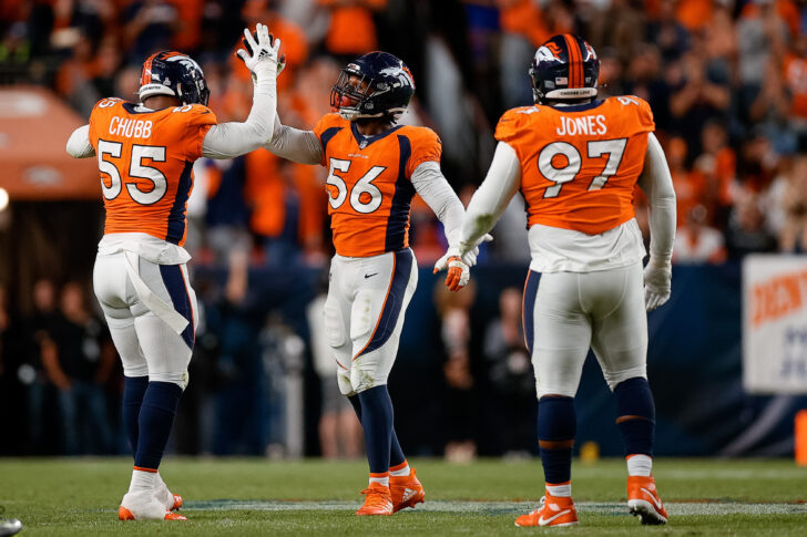Denver Broncos linebacker Baron Browning (56) celebrates after a play with linebacker Bradley Chubb (55) and defensive tackle D.J. Jones (97) in the second quarter against the Indianapolis Colts at Empower Field at Mile High.