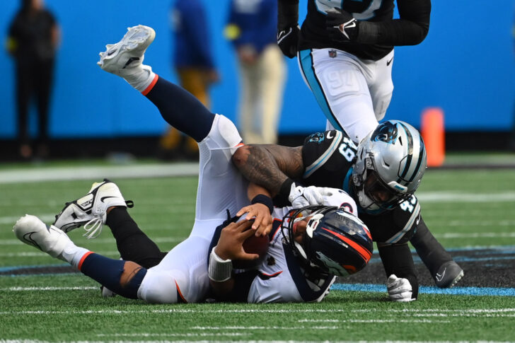 Denver Broncos quarterback Russell Wilson (3) is sacked by Carolina Panthers linebacker Frankie Luvu (49) in the fourth quarter at Bank of America Stadium.