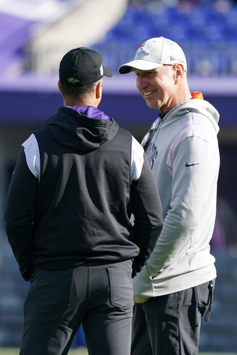 Baltimore Ravens head coach John Harbaugh (left) talks with Denver Broncos coach Jerry Rosburg (right) prior to the game at M&T Bank Stadium.