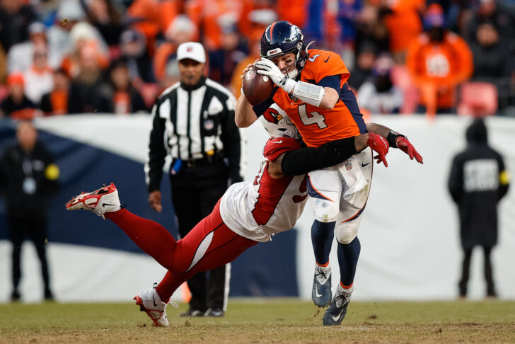 Denver Broncos quarterback Brett Rypien (4) is sacked by Arizona Cardinals defensive end Jonathan Ledbetter (93) in the third quarter at Empower Field at Mile High.