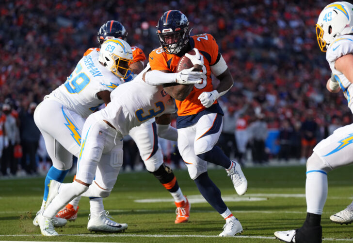 Denver Broncos running back Latavius Murray (28) scores a touchdown past Los Angeles Chargers safety Derwin James Jr. (3) in the first quarter at Empower Field at Mile High.