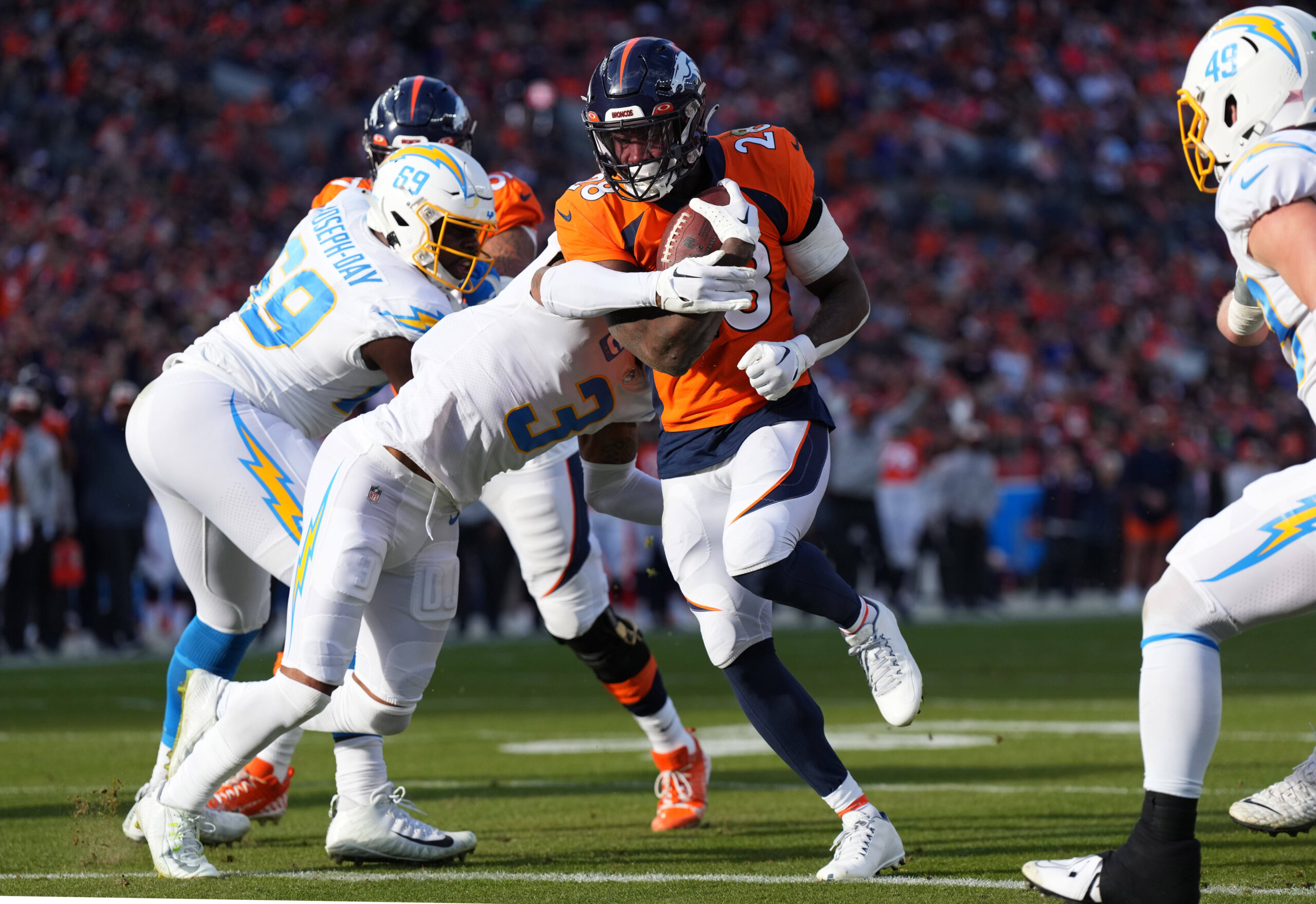 Tyler Badie of the Denver Broncos reacts after rushing for a