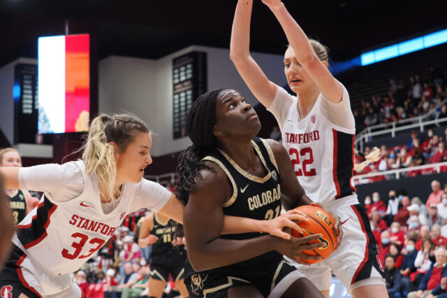 Stanford Cardinal guard Hannah Jump (33) and Stanford Cardinal forward Cameron Brink (22) defend Colorado Buffaloes center Aaronette Vonleh (21) during the first quarter at Maples Pavilion.