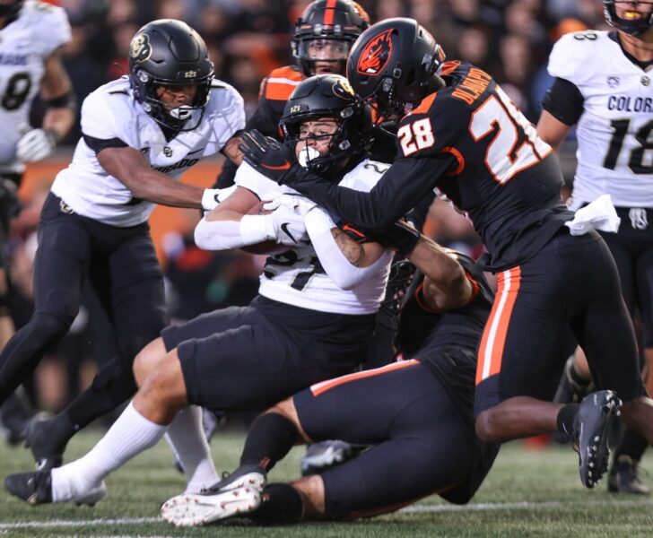 CU Buffs (Colorado Buffaloes) running back Jayle Stacks (21) is brought down by a group of Oregon State defenders during the second quarter at Reser Stadium in Corvallis, Ore. on Saturday, Oct. 22, 2022.