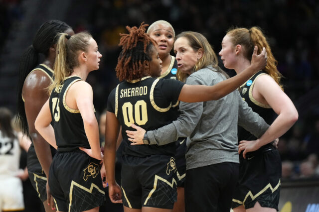 CU Buffs. Colorado Buffaloes coach JR Payne huddles with guard Jaylyn Sherrod (00) against the Iowa Hawkeyes in the second half at Climate Pledge Arena.