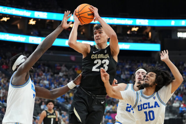 Colorado Buffaloes forward Tristan da Silva (23) looks to shoot between UCLA Bruins forward Adem Bona (3) and guard Tyger Campbell (10) during the second half at T-Mobile Arena.