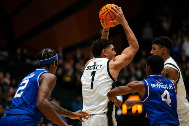 Joel Scott in game one with Colorado State, holding the ball away from two Louisiana Tech defenders.