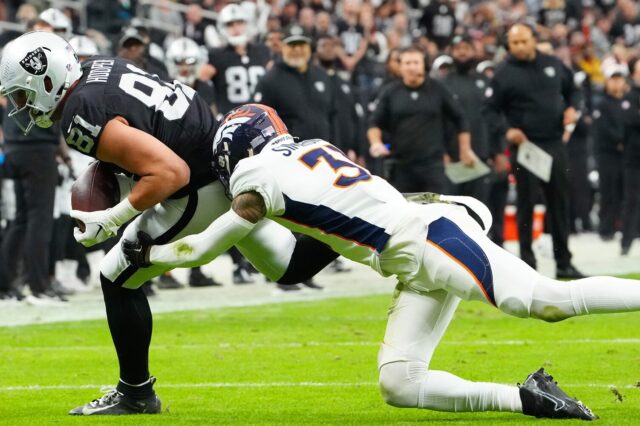Justin Simmons makes a tackle in his last game with the Broncos.