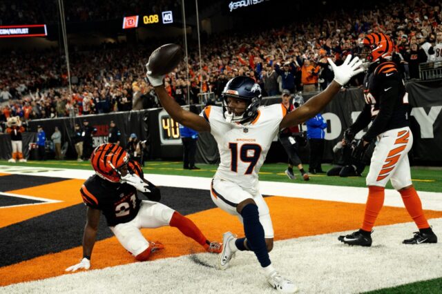Marvin Mims celebrates while two Cincinnati Bengals players can’t believe his catch.