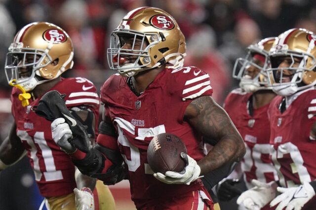 Denver Broncos LB Dre Greenlaw, surrounded by three teammates with the 49ers.