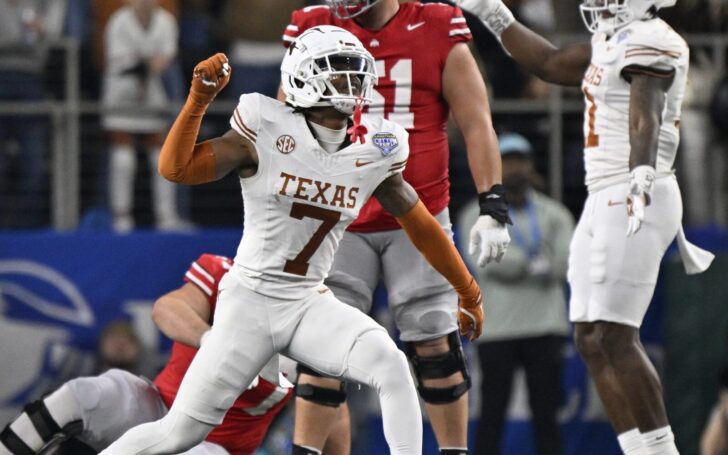 Jahdae Barron celebrates on the field with another Texas teammate.